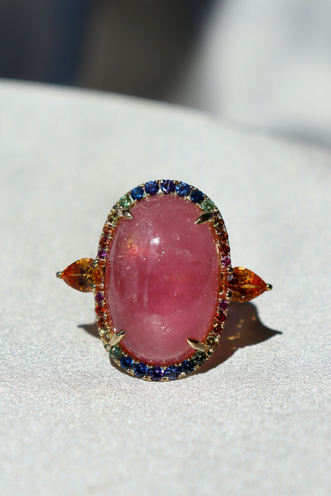 17.30ct Pink Tourmaline Cabochon, Spessartite Garnet, Rainbow Sapphire, & Diamond Ring in 18K Yellow Gold