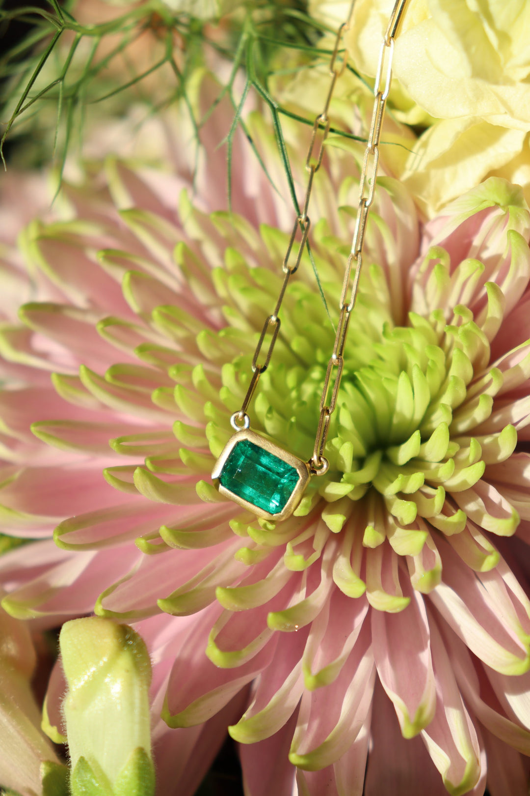 East to West Bezel Emerald Cut Emerald with a 18K Yellow Gold Paperclip Chain